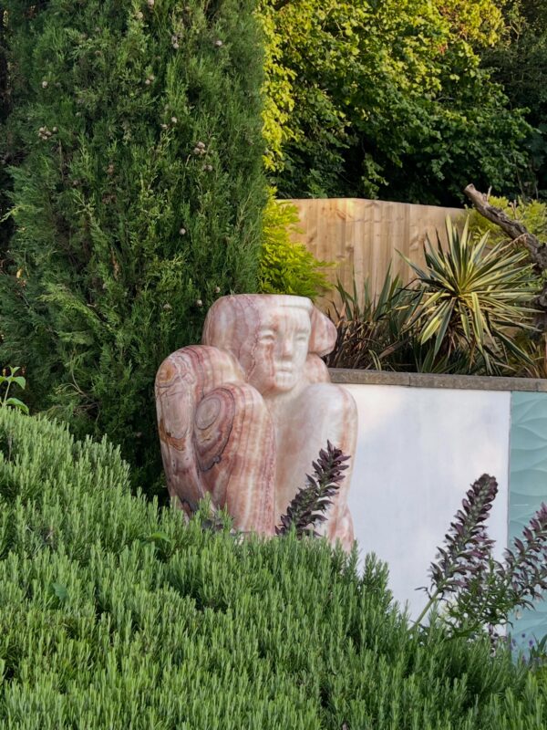 Three sculptures take there place in a beautiful garden in Dorset .